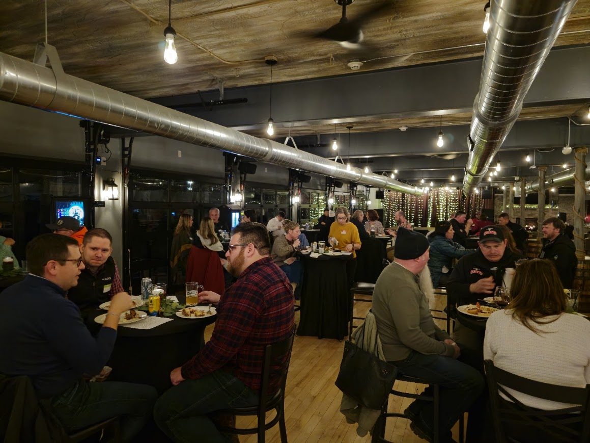 A full room of local business owners talking over dinner at Smoke on the Water