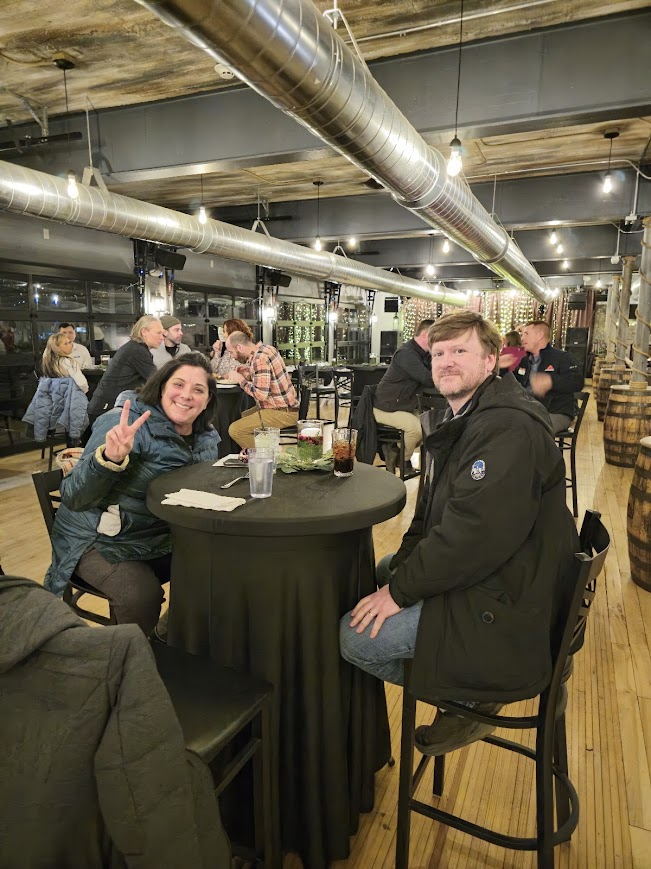 Attendees relaxing at a table during a Local Social evening