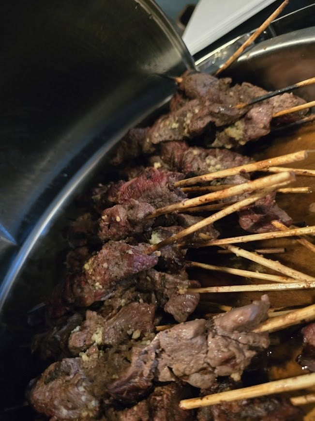 Steak skewers fresh off the grill served at the event