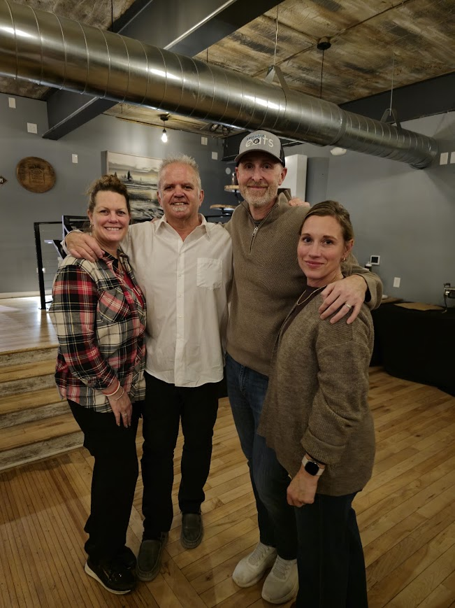 Four attendees posing together at a Local Social event