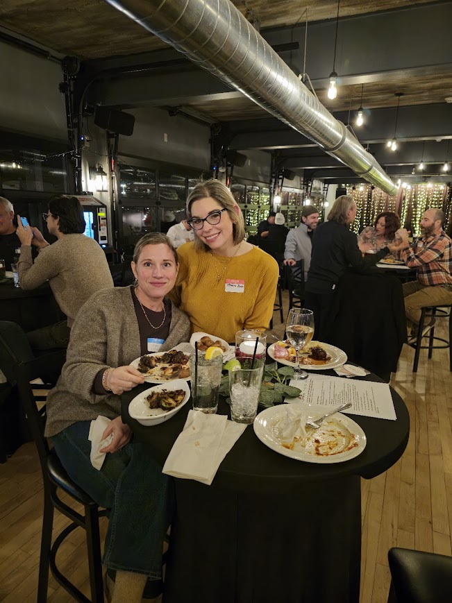Two attendees enjoying dinner together at a Local Social event