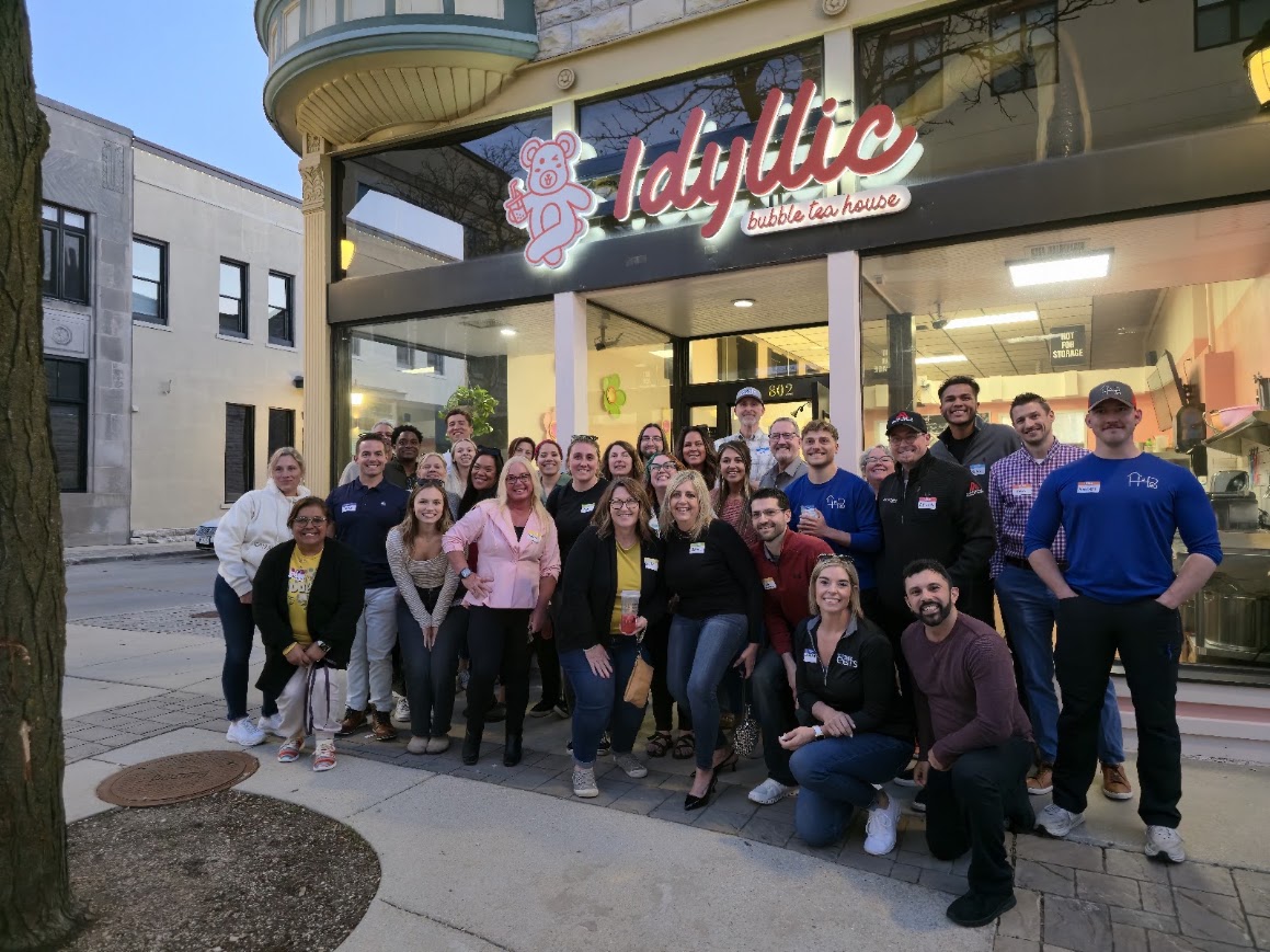 A large group of attendees gathered outside Idyllic Bubble Tea House in downtown Waukesha