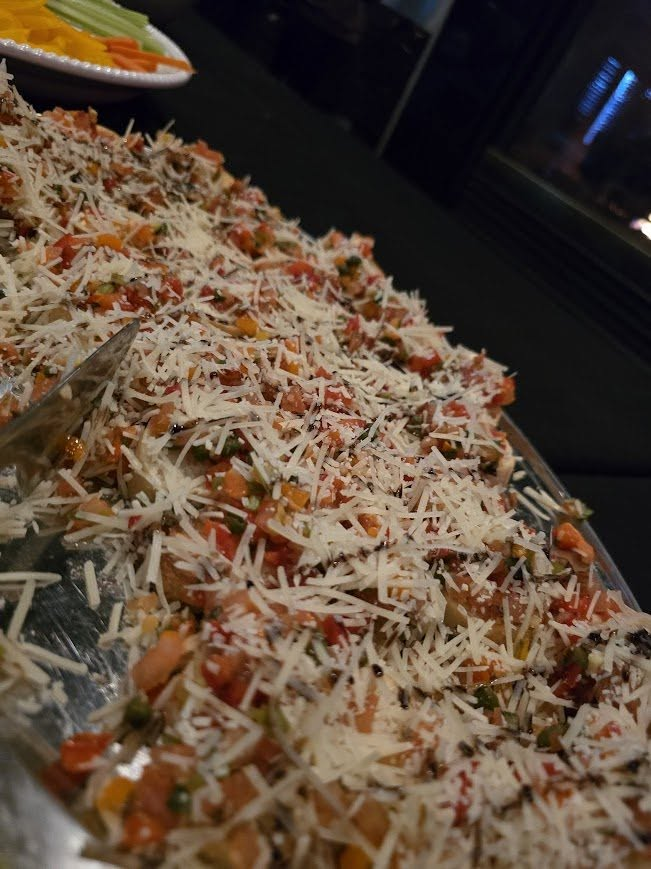 A platter of bruschetta topped with tomatoes and parmesan served at the event